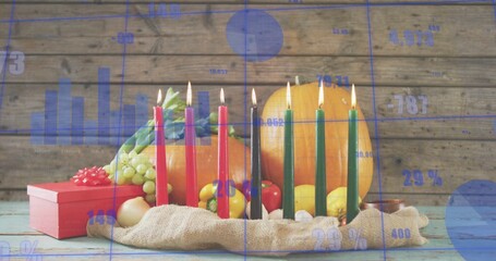 Displaying kinara with seven lit candles on burlap on painted tabletop, pumpkin and blue overlay