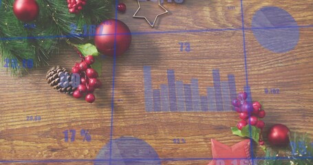 Displaying holiday wooden tabletop with blue data overlays, evergreen sprig, red baubles, pinecone
