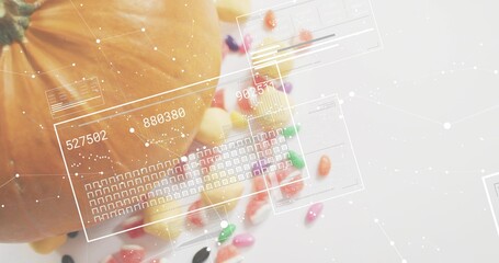 Fototapeta premium Showing partial pumpkin sitting left on white tabletop, with candies and HUD overlays, copy space