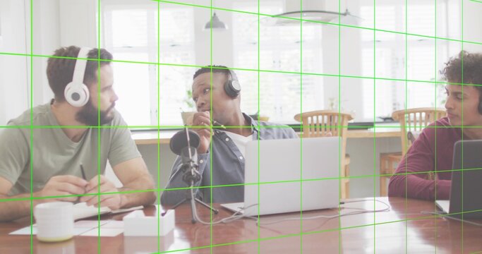Recording three men wearing headphones and leaning into mic in home dining room, with laptops - Powered by Adobe