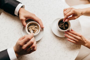 Engaged couple sharing coffee in a cafe
