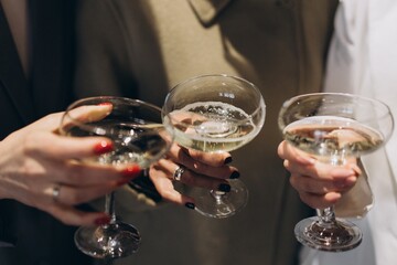People holding champagne glasses celebrating special occasion