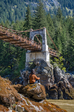Woman contemplating Old Alexandra Bridge in British Columbia, Canada