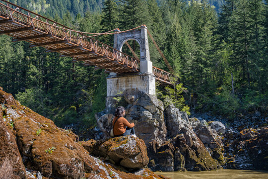 Woman contemplating Old Alexandra Bridge in British Columbia, Canada