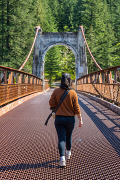 Woman walking Old Alexandra Bridge in British Columbia, Canada