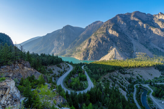 Seton Lake and a winding u turn road traversing a mountain landscape
