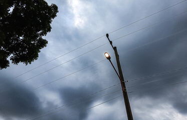 Soft light breaks through a gloomy sky, creating a dramatic contrast between dark clouds and gentle brightness. The scene evokes calmness, depth, and a sense of quiet hope.