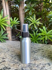 Spray Bottle in Garden Setting with Green Leaves