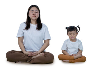 Mother teaching her young daughter to meditate, sitting peacefully in a cross-legged pose  isolated on white with clipping path.