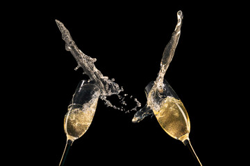 Two Champagne Glasses with Overflowing Bubbly on Black Background New Year Celebration