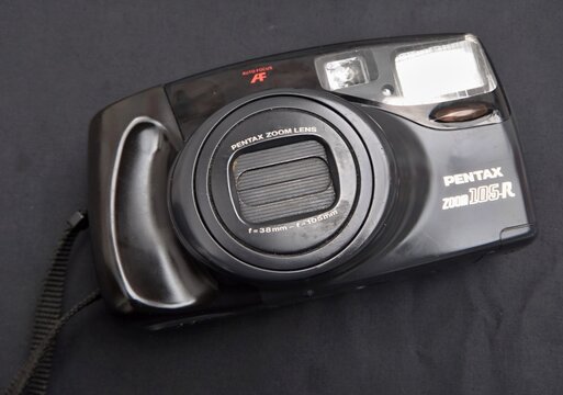 Pentax Zoom 105-R vintage film camera on black surface