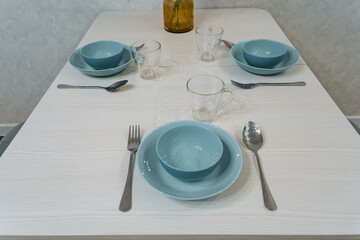 chic understated teal setting, elegant table setup featuring serene modern tealthemed accessories, refined twoperson dining area with minimalist design and soothing teal decorative elements