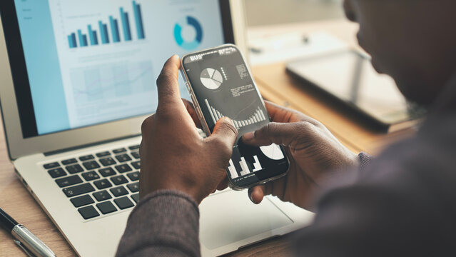 Businessman reviewing financial graphs on screen