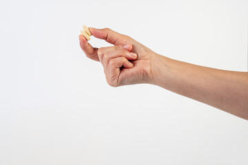 Medicine or vitamins in hand on white background
