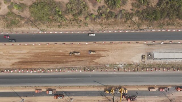 Drone footage a construction working tractor is refining the soil in preparation for laying asphalt The process of making a highway