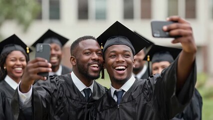 Joyful young graduates smiling and taking selfies in their caps and gowns outdoors during a graduation ceremony celebration - Powered by Adobe