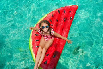 Child in swimming pool. Having fun on vacation at the hotel pool. Colorful vacation concept.
