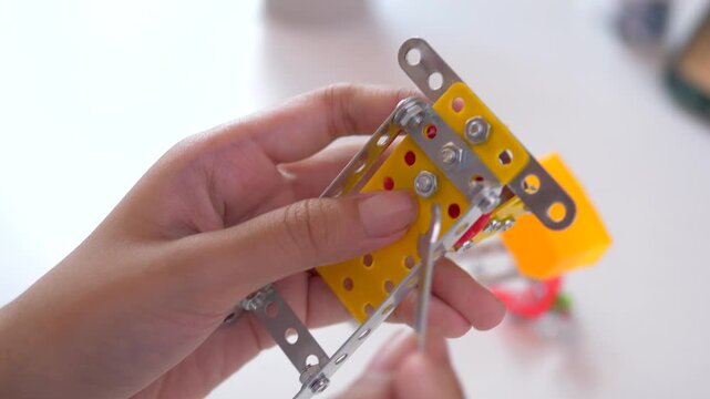 Close up of a mother and child assembling a DIY robot made from 3D printed parts, capturing family bonding, STEM learning and creative development through hands on technology at home