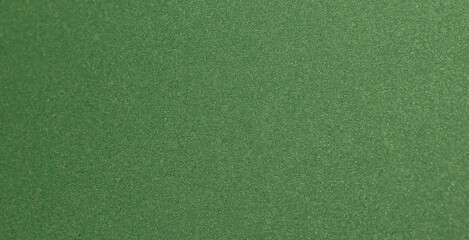 Deep forest green paper background with a smooth matte texture and subtle geometric patterns..