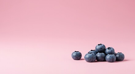 Vibrant blueberries rest against a soft, pastel pink background, creating a sweet and appealing blend of cool and warm colors ,still life ,ingredient ,delicate