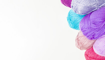 Bright yarn balls on a white background for needlework and sewing with an empty area