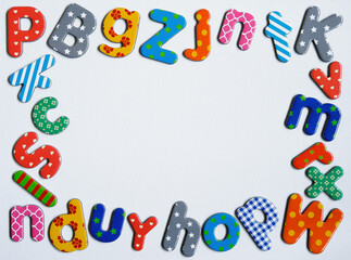Colorful Magnetic Letters Border Frame on White Background
