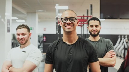Team of personal trainers posing together in gym