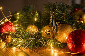 Gift key house with a keychain backdrop of Christmas tree. Building, design, project, moving to new house, mortgage, rent and purchase real estate. A gift for New Year, Christmas