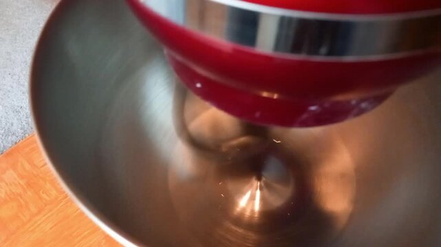 Close up view of dough hook in mixer at high speed with sounds of mixing and action effects present