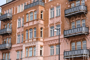 Facade close up architecture in Helsingborg Sweden featuring brick buildings with balconies, illustrate urban construction renovation projects or cityscapes in a European setting.