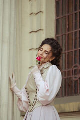 Fototapeta premium Woman with a rose in an old building