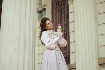 Fototapeta premium Woman with a rose in an old building