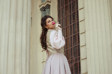 Fototapeta premium Woman with a rose in an old building