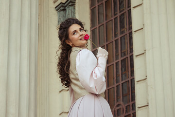 Fototapeta premium Woman with a rose in an old building