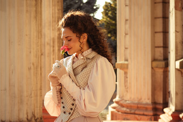 Fototapeta premium Woman with a rose in an old building