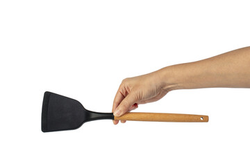 Hand with Black plastic kitchen spatula, kitchenware for cooking on transparent background.