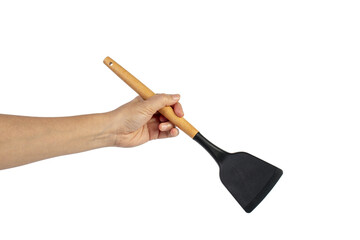 Hand with Black plastic kitchen spatula, kitchenware for cooking on transparent background.