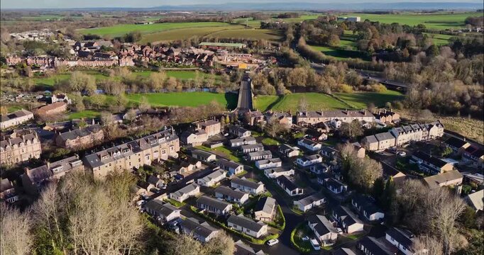 Aerial drone footage of the town of Ripon in North Yorkshire in the UK showing typical British housing estates and streets along side the Yorkshire country side in the autumn time.