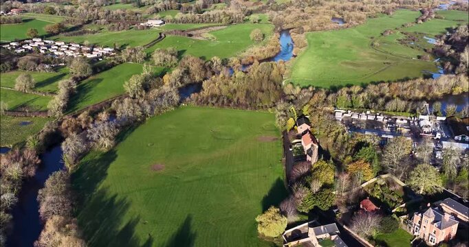 Aerial drone footage of the town of Ripon in North Yorkshire in the UK showing typical British housing estates and streets along side the Yorkshire country side in the autumn time.