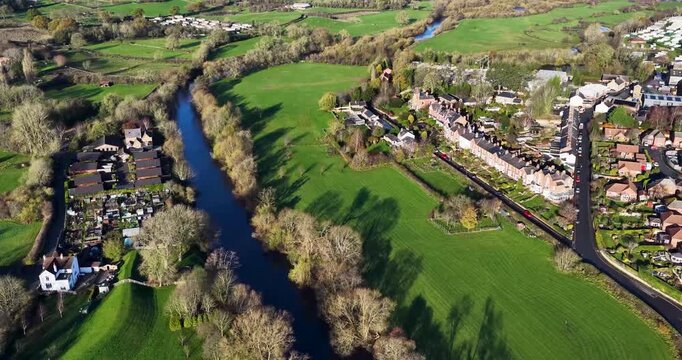 Aerial drone footage of the town of Ripon in North Yorkshire in the UK showing typical British housing estates and streets along side the Yorkshire country side in the autumn time.