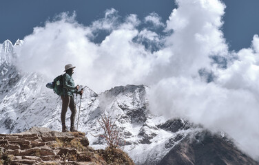 Sunny Day on Trek to Everest: Hiker Trekker at Everest Base Camp Trail Enjoying View of Himalayan Range in Nepal.
