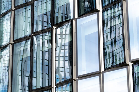 This abstract representation highlights a section of a glass-covered building, creating fascinating reflections and distortions that invoke intrigue and curiosity.