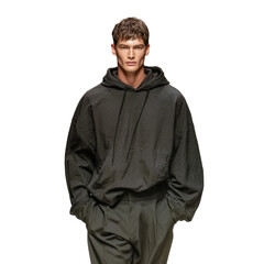 Fashion Forward: A male model confidently showcases an oversized dark-colored hoodie. The image highlights the fusion of high fashion and street style.