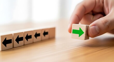 Choosing a new path A hand positions a green arrow, symbolizing innovation, unique vision, and strategic direction change
