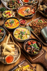 many different thai food dishes on table in modern restaurant in bangkok thailand