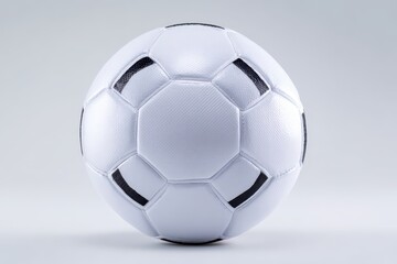 Fototapeta premium Monochrome soccer ball with stitching detail on white surface