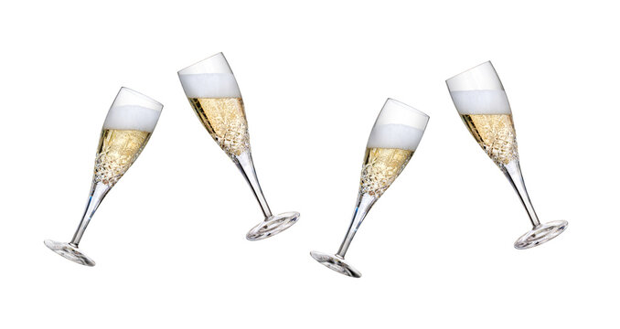 A collection of champagne glasses, flutes, tilted with fizzy wine as a birthday or New Year celebration with fizzy frothy bubbles with different fill levels isolated on a transparent background.
