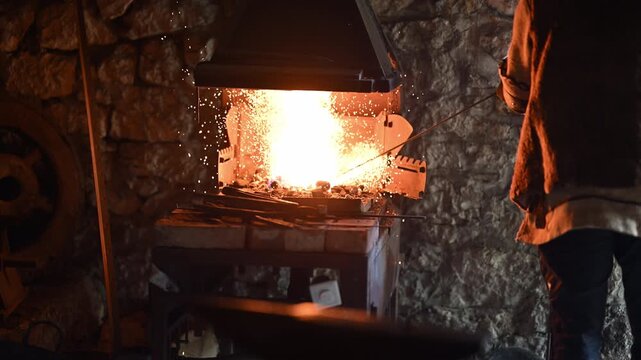 A Viking blacksmith with a white beard and braided hair works intently at a forge, hammering glowing metal on an anvil, with flames flickering in the background of a stone workshop cinematic slow