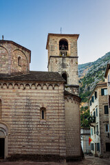 Fototapeta premium The bell tower or campanile of the Church of St. Mary Collegiate or the church of St. Osanna in the city of Kotor at dawn. Montenegro. Vertical view.