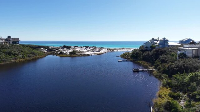 Forward drone fly toward the endpoint of Draper Lake meeting Gulf of Mexico turquoise water, Old Florida Beach, Florida, USA